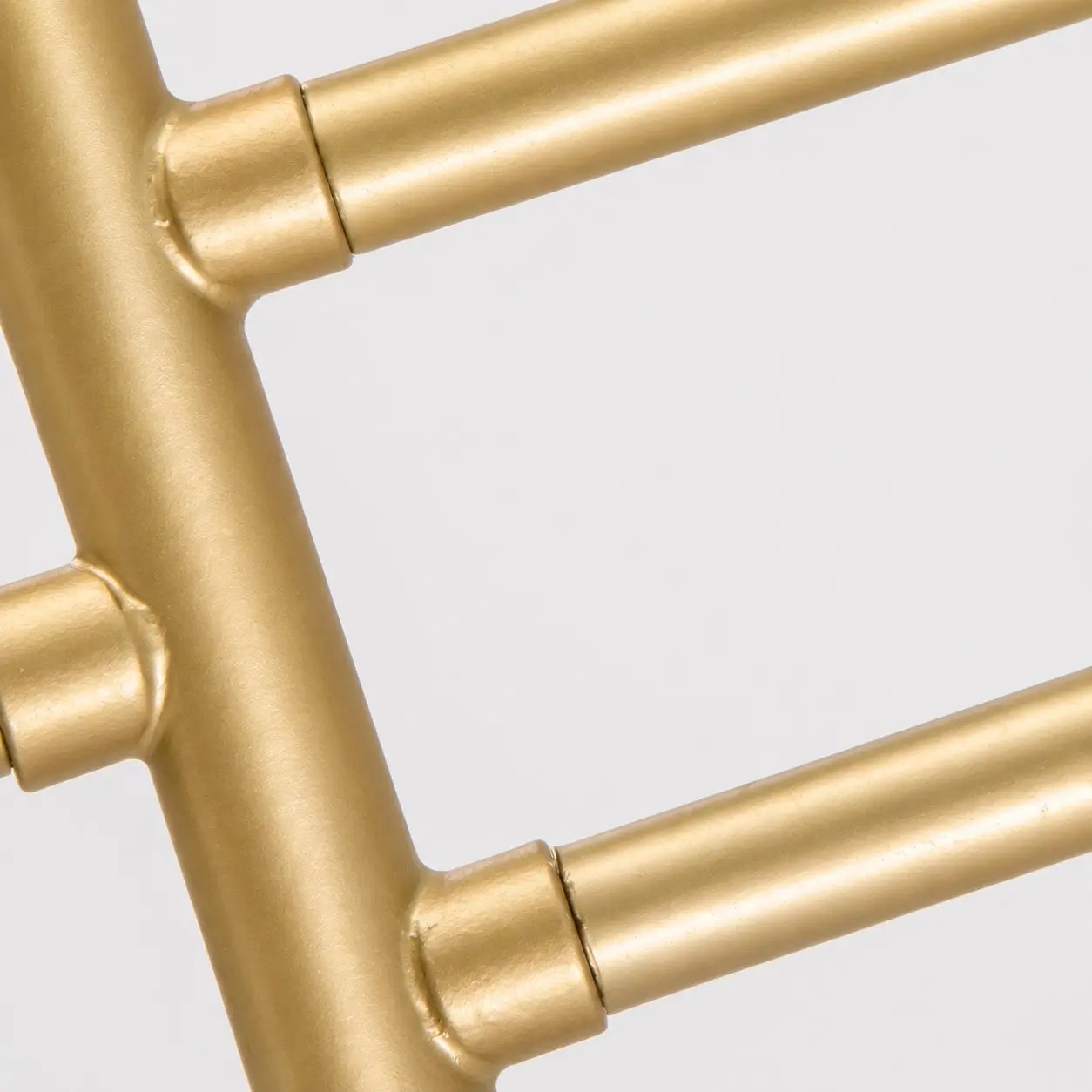 Close-up of the curved gold-tone metal frame