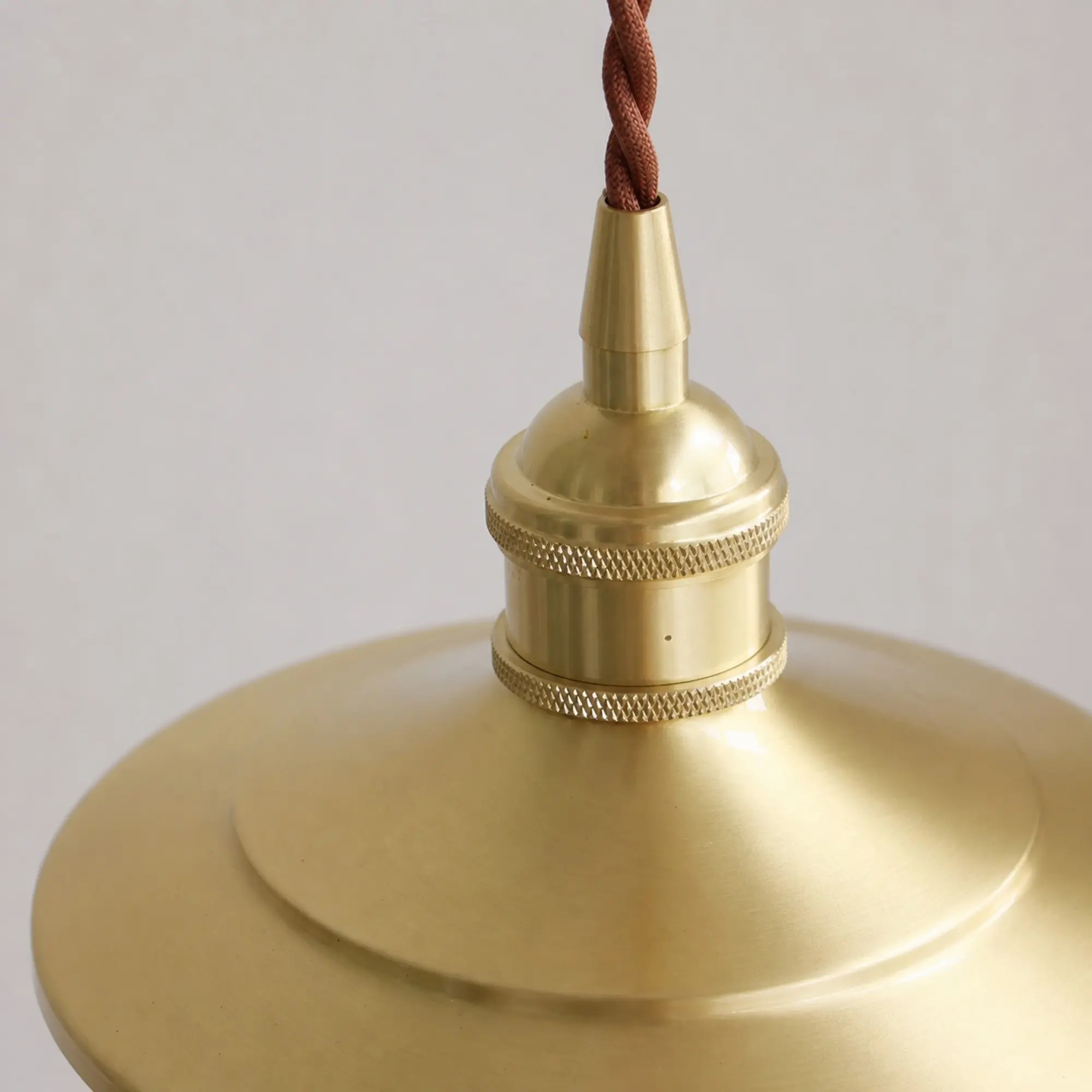 Close-up of polished brass socket and knurled rings