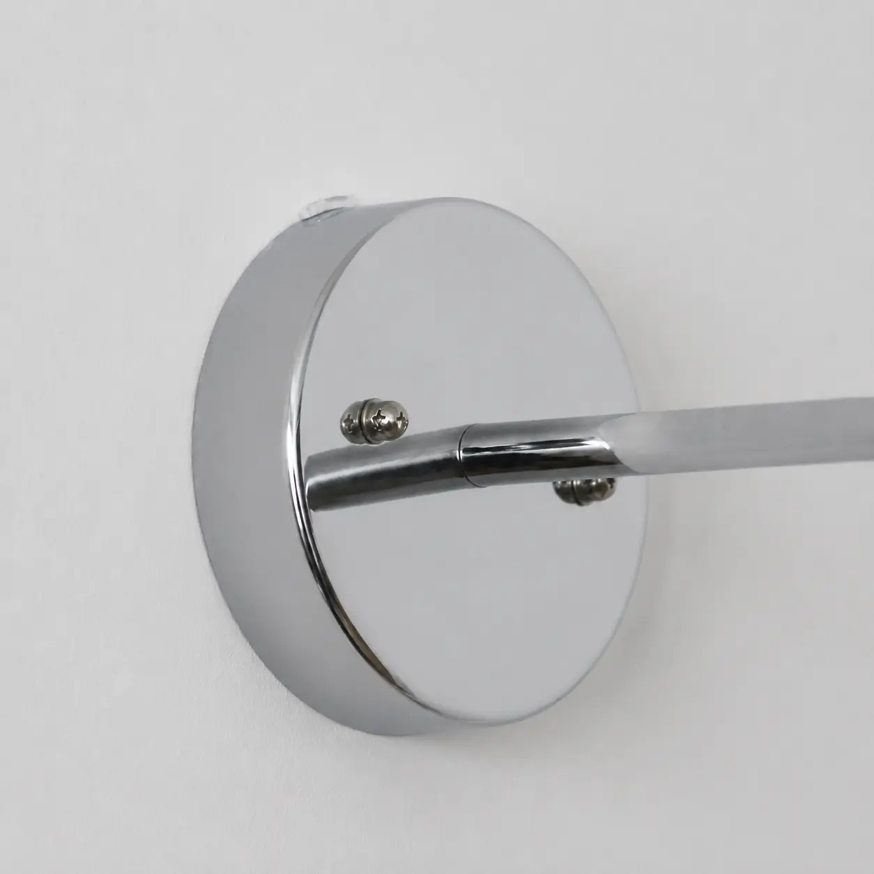 Wall plate and curved arm connection detail